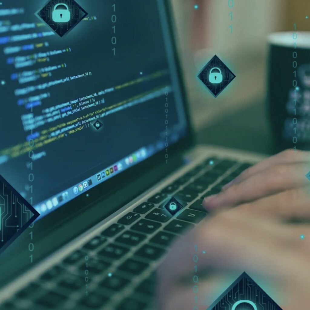 A Person Typing Code On A Laptop