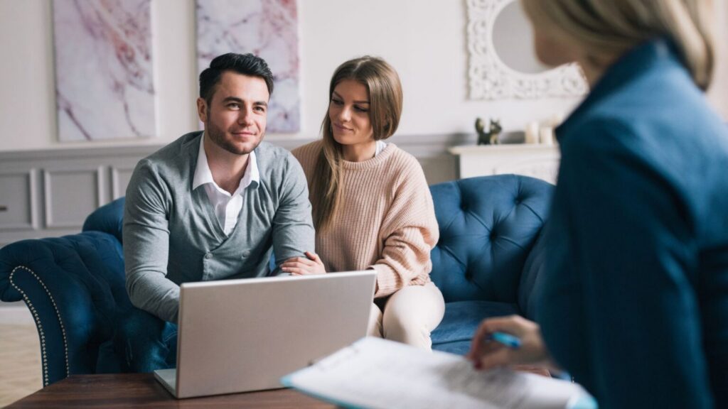 Couple discussing IT services for insurance company with advisor