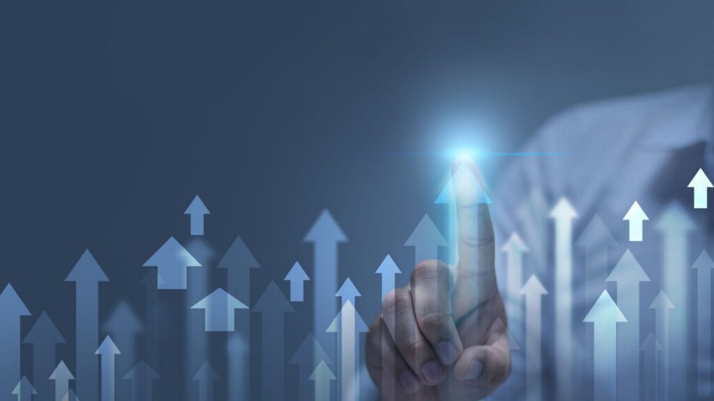Hand touching digital interface with upward growth arrows