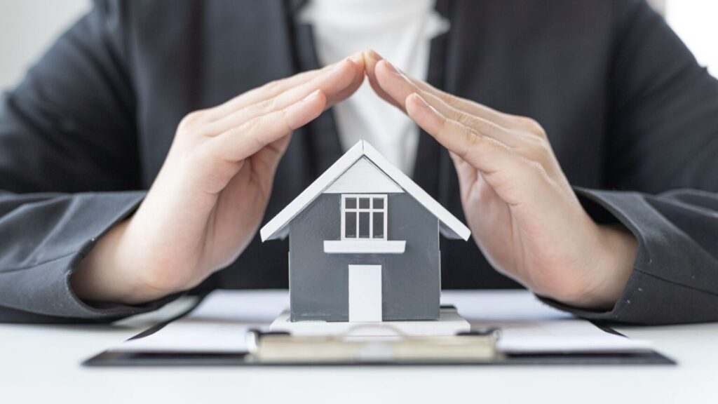Hands protecting house model