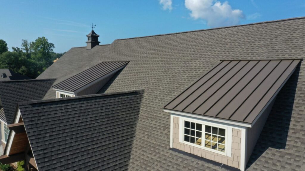 house roof with metal and shingle roofing sections