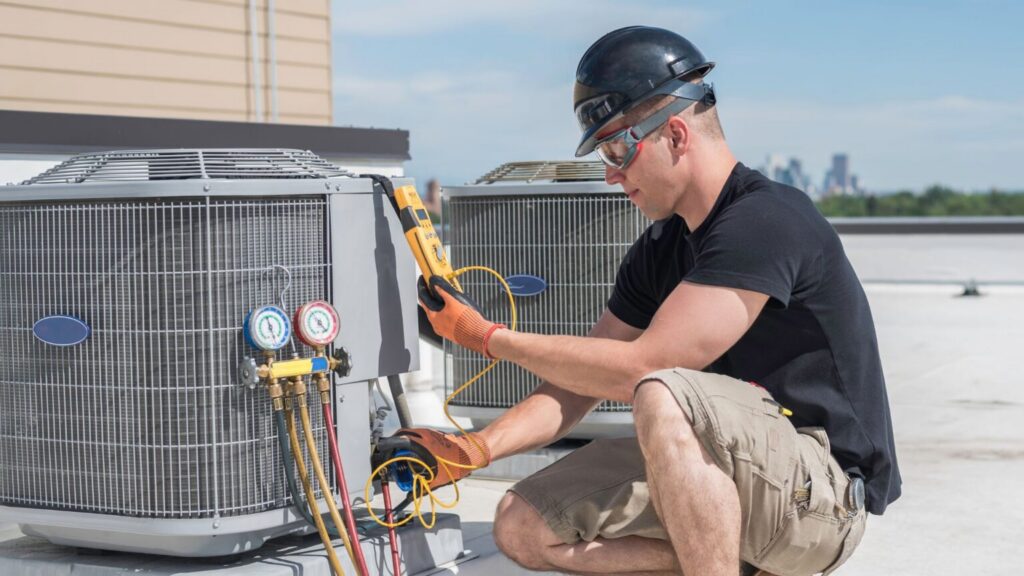 HVAC technician servicing outdoor air conditioning unit