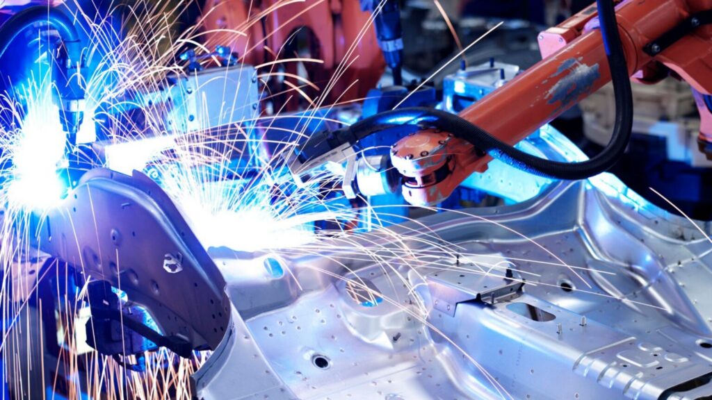 industrial robot welding car body in manufacturing plant