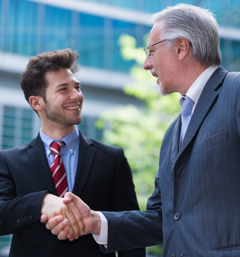 It Consultants Shaking Hands Outside An Office Building