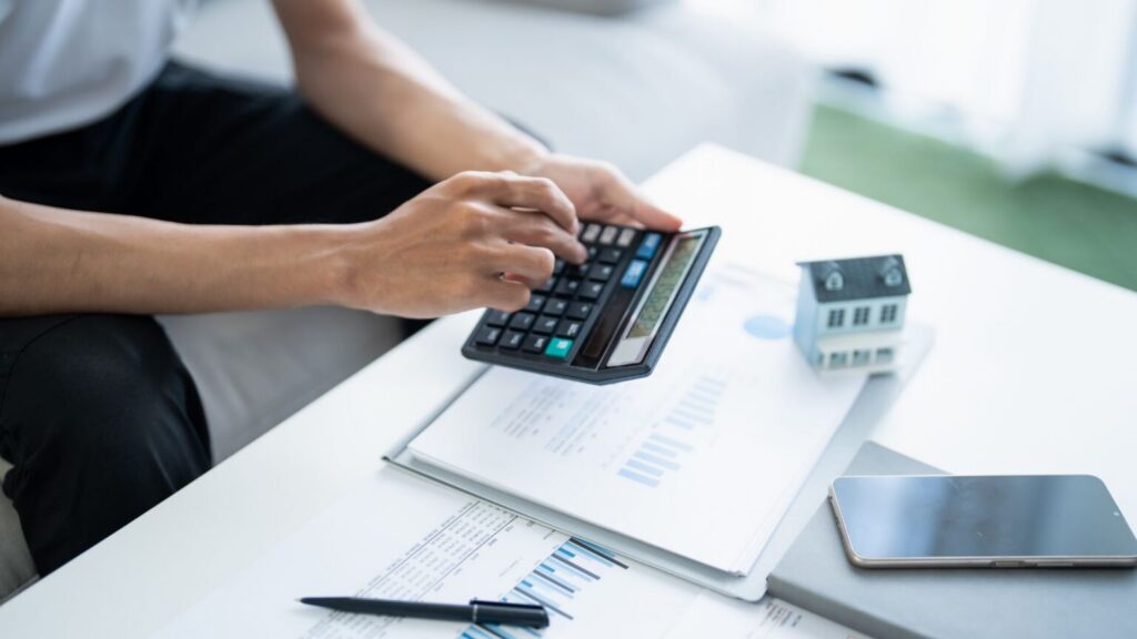 person calculating costs with calculator
