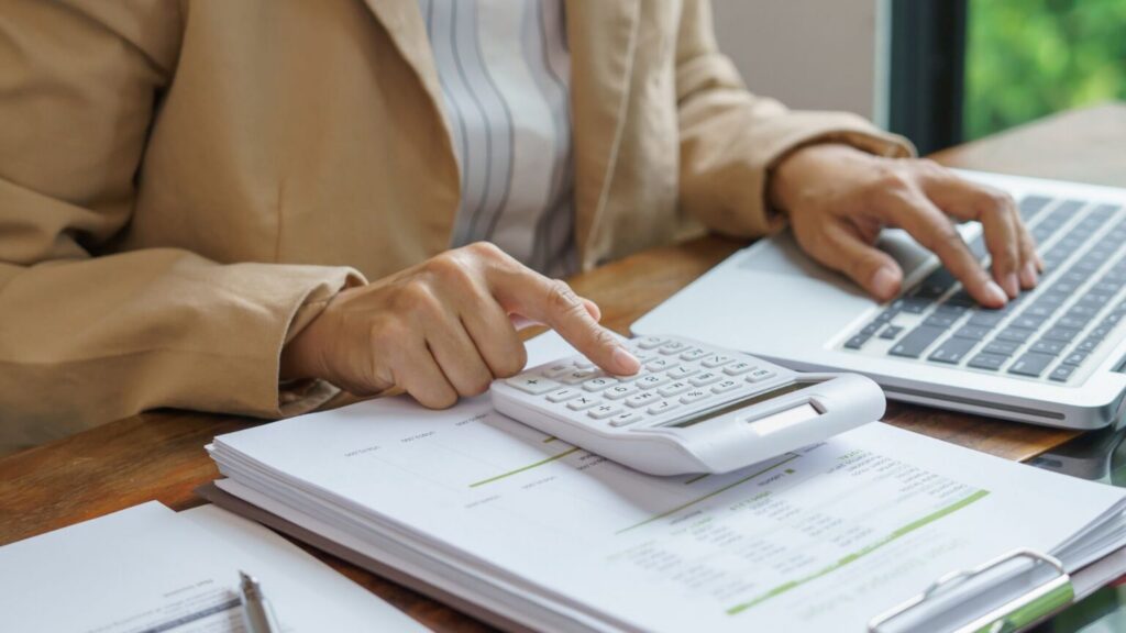 Professional using calculator for financial calculations