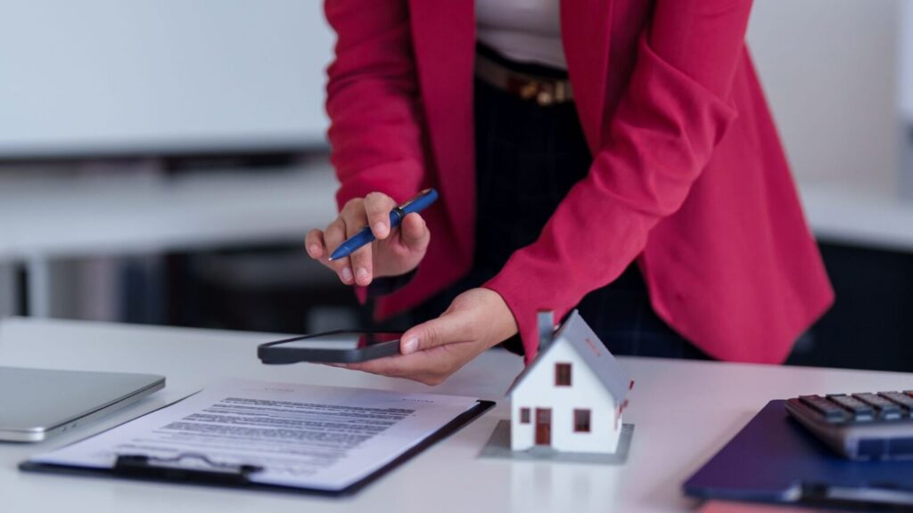 real estate agent calculating property value with calculator