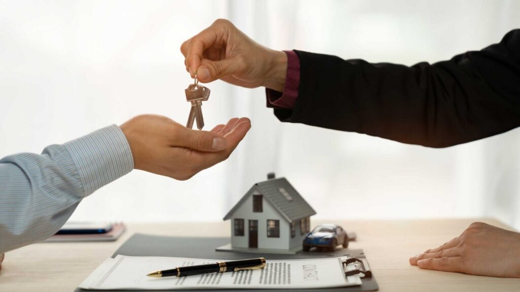 real estate agent handing house keys to new homeowner