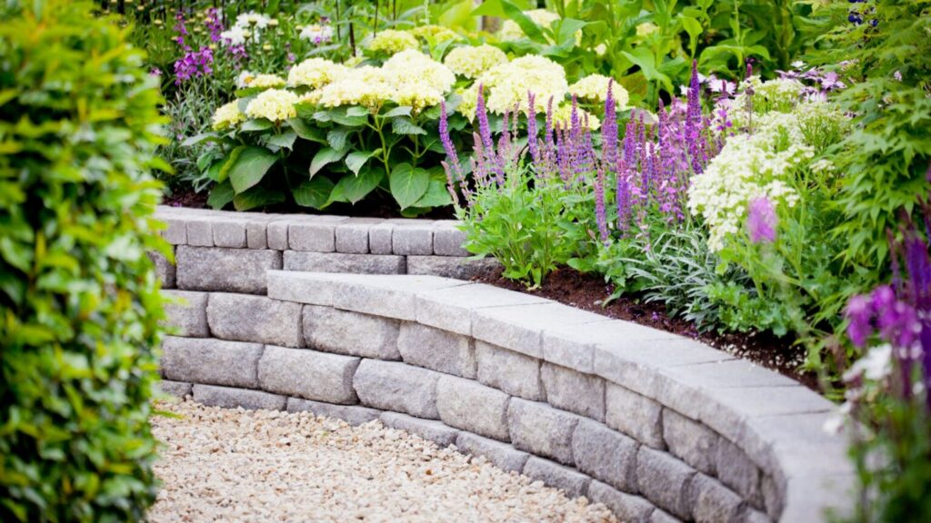 stone retaining wall with colorful garden flowers