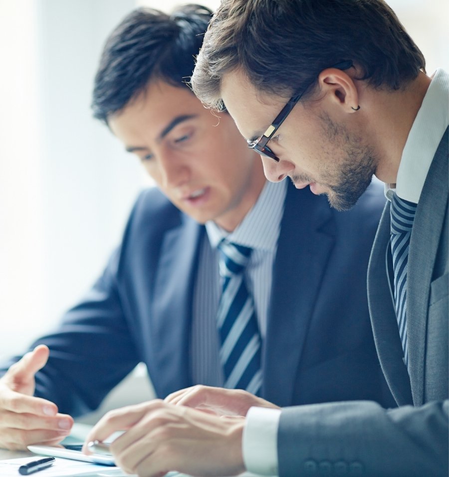 Two IT Consultants Discussing On A Tablet